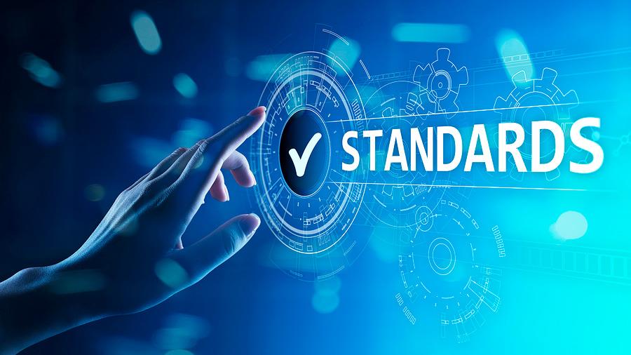 ISO standards concept showing a hand touching a screen with the word "standards" on it.