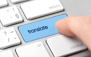 Concept for machine translation - user pushing a "translate" button on a keyboard